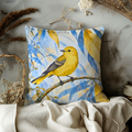 Yellow Bird Pillow Cover | Perched on a Curved Branch Among Yellow Leaves Against Blue Foliage